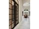 Spacious hallway with an archway to the dining room with black grids windows at 8336 Boyla Ct, Windermere, FL 34786