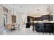 Open-concept kitchen and dining area with modern appliances, stylish seating, and plenty of natural light at 8336 Boyla Ct, Windermere, FL 34786