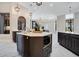 A modern island with a stainless-steel microwave and faucet, dark cabinets, and a marble floor at 8336 Boyla Ct, Windermere, FL 34786