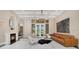 Bright and spacious living room with marble floors, a fireplace, and stylish modern furniture at 8336 Boyla Ct, Windermere, FL 34786