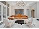 Bright and spacious living room with marble floors, a fireplace, and stylish modern furniture at 8336 Boyla Ct, Windermere, FL 34786