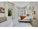 Spacious main bedroom with marble floors, decorative wall hangings and an abundance of natural light from plentiful windows at 8336 Boyla Ct, Windermere, FL 34786