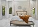 Bright main bedroom featuring a cozy bed, stylish wall decor, and elegant curtains at 8336 Boyla Ct, Windermere, FL 34786