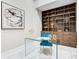 Stylish home office featuring a glass desk, built-in shelving, and modern decor at 8336 Boyla Ct, Windermere, FL 34786