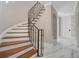 Staircase with curved wrought iron banister and white marble floors leading to the upper level at 8336 Boyla Ct, Windermere, FL 34786