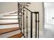Beautiful staircase with hardwood treads, white risers, and ornate iron railing at 8336 Boyla Ct, Windermere, FL 34786