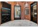Custom wine cellar features brick walls, black shelving with lighting, and tile flooring at 8336 Boyla Ct, Windermere, FL 34786