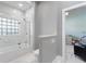 Elegant bathroom featuring a marble walk-in shower and glass block window at 8606 Summerville Pl, Orlando, FL 32819