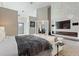 Spacious main bedroom featuring a modern fireplace, TV, and an en-suite bathroom at 8606 Summerville Pl, Orlando, FL 32819