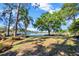 Lush backyard with mature trees and lake access and dock at 9318 Lake Hickory Nut Dr, Winter Garden, FL 34787