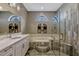 Modern bathroom with dual-pane windows, a glass shower, and a marble-topped vanity, exuding elegance at 9318 Lake Hickory Nut Dr, Winter Garden, FL 34787