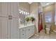 Cozy bathroom with white vanity, decorative lights, tile floors, and combination shower and tub at 9318 Lake Hickory Nut Dr, Winter Garden, FL 34787