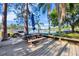 Wooden deck with picnic table overlooking a serene lake at 9318 Lake Hickory Nut Dr, Winter Garden, FL 34787
