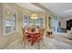 Cozy breakfast nook features a round table, white tile floors, plantation shutters, and view to the outdoors at 9318 Lake Hickory Nut Dr, Winter Garden, FL 34787