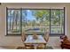 Dining area with a view of the lake and a small table with seating for two at 9318 Lake Hickory Nut Dr, Winter Garden, FL 34787