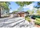 Home with large driveway leading to a two car garage and landscaped backyard at 9318 Lake Hickory Nut Dr, Winter Garden, FL 34787