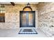 Charming home featuring brick facade, iron double doors, and 'Home Sweet Home' welcome mat at 9318 Lake Hickory Nut Dr, Winter Garden, FL 34787