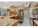 Spacious kitchen features wooden cabinets, white countertops, stainless steel appliances, and opens to the living area at 9318 Lake Hickory Nut Dr, Winter Garden, FL 34787