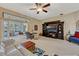 Open-concept living room with sliding glass doors to screened patio and a large media center at 9318 Lake Hickory Nut Dr, Winter Garden, FL 34787