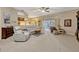 Spacious living room with plush carpeting, neutral walls, large windows, and comfortable reclining furniture at 9318 Lake Hickory Nut Dr, Winter Garden, FL 34787