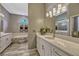Beautiful main bathroom with a large vanity area, tub, and shower with decorative lighting and mirrors at 9318 Lake Hickory Nut Dr, Winter Garden, FL 34787
