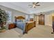 Spacious main bedroom has neutral walls, carpeting, traditional furniture, and access to the main bathroom at 9318 Lake Hickory Nut Dr, Winter Garden, FL 34787
