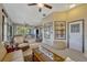 Cozy sunroom with comfortable seating and views of the surrounding landscaping at 9318 Lake Hickory Nut Dr, Winter Garden, FL 34787