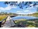 Scenic lake view from the end of a wooden dock with boat at 9318 Lake Hickory Nut Dr, Winter Garden, FL 34787