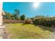 Spacious backyard with lush grass, mature trees, and a privacy fence at 9833 Camberley Cir, Orlando, FL 32836