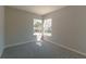 Bright bedroom with neutral gray walls and carpet, featuring two windows at 9833 Camberley Cir, Orlando, FL 32836