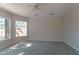 Spacious bedroom with neutral carpet, ceiling fan, and natural light at 9833 Camberley Cir, Orlando, FL 32836