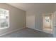 Bedroom with closet and doorway to hall, neutral walls and carpeting at 9833 Camberley Cir, Orlando, FL 32836