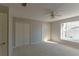 Bright bedroom with neutral walls and carpet, featuring a ceiling fan and double closets at 9833 Camberley Cir, Orlando, FL 32836