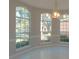 Dining room featuring tile floors, arched windows, and a decorative light fixture at 9833 Camberley Cir, Orlando, FL 32836