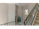 A grand foyer features an elegant staircase with an ornate iron railing and large windows at 9833 Camberley Cir, Orlando, FL 32836