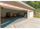 Spacious three-car garage providing ample parking and storage, with a side entry door at 9833 Camberley Cir, Orlando, FL 32836