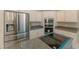 Close up view of stainless steel fridge, granite countertops, white cabinets, and cooktop with blue trim accents at 9833 Camberley Cir, Orlando, FL 32836