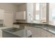 Modern kitchen with gray granite countertops, stainless steel appliances, and abundant cabinet space at 9833 Camberley Cir, Orlando, FL 32836