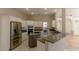 Open concept kitchen with stainless steel appliances, granite countertops, white cabinetry, and an open serving bar at 9833 Camberley Cir, Orlando, FL 32836