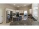 Spacious kitchen boasts stainless steel appliances, granite countertops, white cabinetry, and center island at 9833 Camberley Cir, Orlando, FL 32836