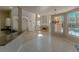 Bright living room features tile floors, fireplace, built-in shelving, and large windows with views of the pool at 9833 Camberley Cir, Orlando, FL 32836