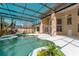 Beautiful view of the screened-in pool and patio area, showcasing lush plantings and the home's architectural details at 9833 Camberley Cir, Orlando, FL 32836
