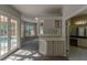 Sitting room with built-in bar area leading to an ensuite bathroom at 9833 Camberley Cir, Orlando, FL 32836