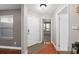 Foyer with hardwood flooring, neutral wall paint, a white front door and casing, and a dark brown entry rug at 995 Casa Del Sol Cir, Altamonte Springs, FL 32714