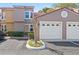 Exterior elevation showing a well-maintained two-car garage with a charming tile roof and manicured landscaping at 995 Casa Del Sol Cir, Altamonte Springs, FL 32714