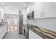 Bright modern kitchen with stainless steel appliances and dark granite countertops at 995 Casa Del Sol Cir, Altamonte Springs, FL 32714