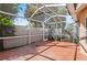 Screened patio with red flooring, white screen, and a white fence, perfect for enjoying the outdoors at 995 Casa Del Sol Cir, Altamonte Springs, FL 32714