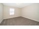 Bedroom features neutral carpet, base trim, and bright window at 9951 Alliteration Aly, Winter Garden, FL 34787