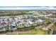 Breathtaking aerial view capturing the beauty of a neighborhood with lush greenery, a lake, and a playground at 1003 Jack Nicklaus Ct, Kissimmee, FL 34747