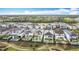 An expansive aerial view of a residential area featuring well-manicured lawns and exquisite homes in a planned community at 1003 Jack Nicklaus Ct, Kissimmee, FL 34747